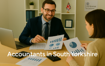 A professional accountant in a modern South Yorkshire office explains financial charts to a client across a tidy desk with a laptop, spreadsheets, and calculators. A small British flag and HMRC document in the background suggest a UK business setting. Overlay text reads Accountants in South Yorkshire