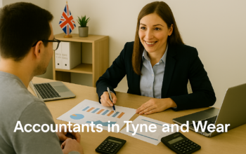 A professional accountant in a modern Tyne and Wear office explains financial charts to a client across a tidy desk with a laptop, spreadsheets, and calculators. A small British flag and HMRC document in the background suggest a UK business setting. Overlay text reads Accountants in Tyne and Wear