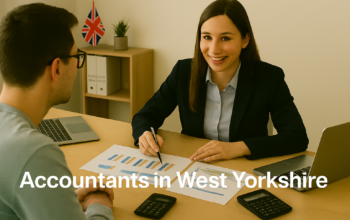 A professional accountant in a modern West Yorkshire office explains financial charts to a client across a tidy desk with a laptop, spreadsheets, and calculators. A small British flag and HMRC document in the background suggest a UK business setting. Overlay text reads Accountants in West Yorkshire